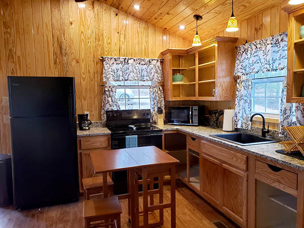 Kitchen of the couples cabins with the table set out and the side raised