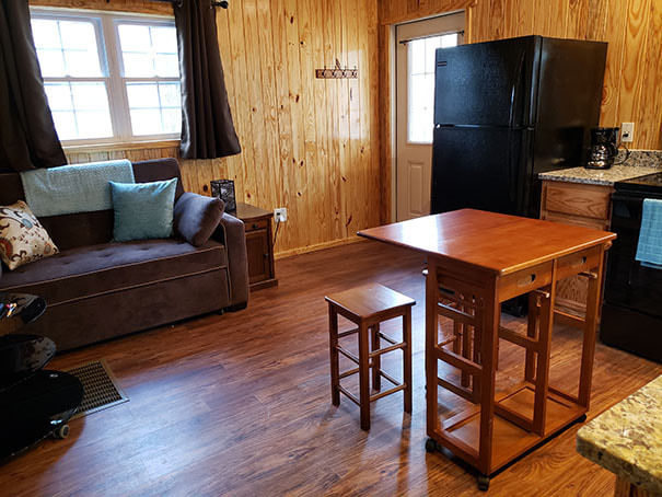 Living room area of the couples cabins, the kitchen table and part of the kitchen